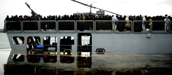 Migrants wait to disembark from a ship on February 17, 2015 in the port of Porto Empedocle, south Sicily, following a rescue operation of migrants as part of the International Frontex plan Migrants wait to disembark from a ship on February 17, 2015 in the port of Porto Empedocle, south Sicily, following a rescue operation of migrants as part of the International Frontex plan - Sputnik International