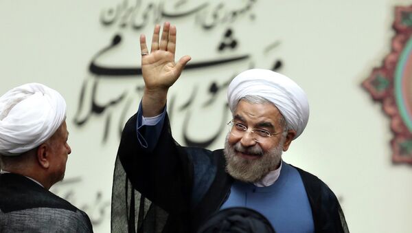 Iran's new President Hasan Rouhani, waves after swearing in at the parliament, in Tehran, Iran - Sputnik International
