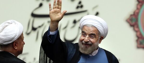 Iran's new President Hasan Rouhani, waves after swearing in at the parliament, in Tehran, Iran - Sputnik International
