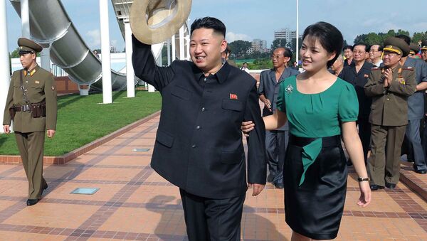 North Korean leader Kim Jong Un, center, accompanied by his wife Ri Sol Ju, right, waves to the crowd as they inspect the Rungna People's Pleasure Ground in Pyongyang - Sputnik International
