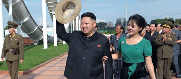 North Korean leader Kim Jong Un, center, accompanied by his wife Ri Sol Ju, right, waves to the crowd as they inspect the Rungna People's Pleasure Ground in Pyongyang - Sputnik International