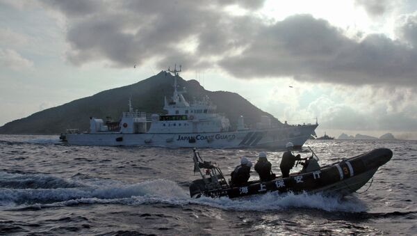 Japanese Coast Guard boat and vessel sail alongside Japanese activists' fishing boat, not in photo, warning the activists away from a group of disputed islands called Diaoyu by China and Senkaku by Japan - Sputnik International