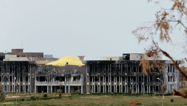 The administration building at the University of Benghazi destroyed building is seen damaged after clashes between members of the Libyan pro-government forces, backed by the locals, and Shura Council of Libyan Revolutionaries, an alliance of former anti-Gaddafi rebels who have joined forces with Islamist group Ansar al-Sharia, in Benghazi March 16, 2015 - Sputnik International
