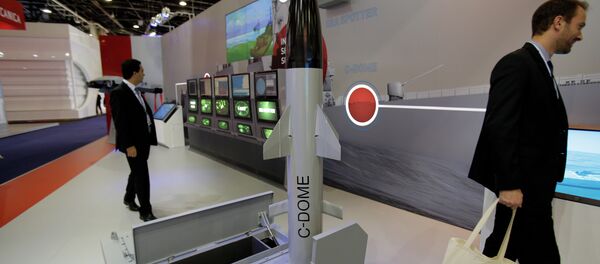 Visitors walk past a model of Israeli weapon company Rafael' C-Dome is presented at the Euronaval show, in Le Bourget, north of Paris. - Sputnik International