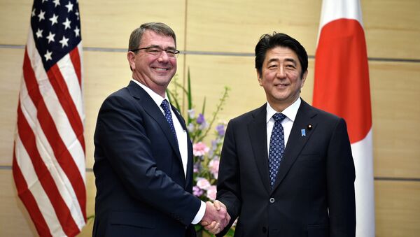U.S. Defense Secretary Ash Carter, left, shakes hands with Japan's Prime Minister Shinzo Abe at the start of their meeting at Abe's official residence in Tokyo. - Sputnik International