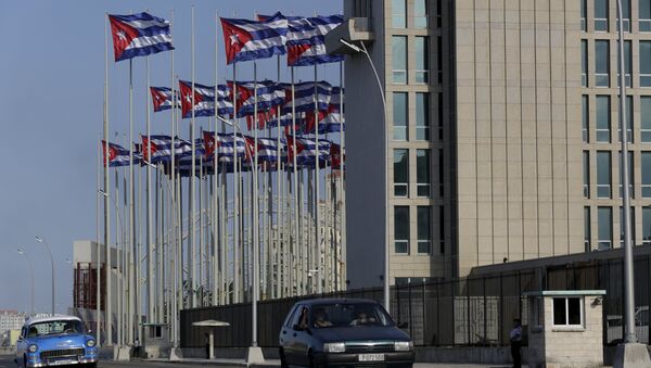 Cuban flags, raised to celebrate the 53rd anniversary of the Young Communist League (UJC) and the 54th anniversary of the Jose Marti Pioneers Organization (OPJM), fly beside the United States Interests Section in Havana (USINT), in Havana April 5, 2015 - Sputnik International