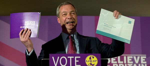 Nigel Farage leader of the UK Independence Party holds up his party's election manifesto, left, and economic policy review, right, during its launch at a media event in Thurrock, England, Wednesday, April 15, 2015 Nigel Farage leader of the UK Independence Party holds up his party's election manifesto, left, and economic policy review, right, during its launch at a media event in Thurrock, England, Wednesday, April 15, 2015 - Sputnik International