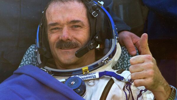 Canadian astronaut Chris Hadfield gestures after the Russian Soyuz space capsule landed some 150 kilometers (94 miles) southeast of the town of Dzhezkazgan in central Kazakhstan - Sputnik International