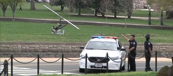 A small helicopter (L) is pictured in this still image taken from video after it landed on the west lawn of the U.S. Capitol in Washington April 15, 2015 - Sputnik International