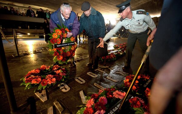 Holocaust survivors and their relatives lay a wreath next to the names of concentration camps during a ceremony marking the annual Holocaust Remembrance Day at the Hall of Remembrance at the Yad Vashem Holocaust memorial, in Jerusalem - Sputnik International