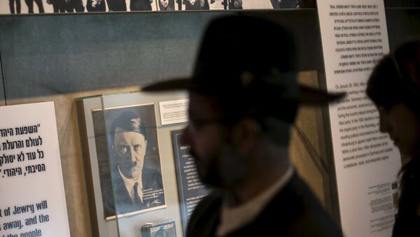 A visitor walks past a photograph of Adolf Hitler displayed at Yad Vashem's Holocaust History Museum in Jerusalem - Sputnik International