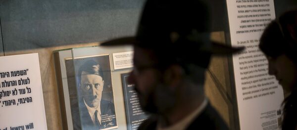 A visitor walks past a photograph of Adolf Hitler displayed at Yad Vashem's Holocaust History Museum in Jerusalem - Sputnik International