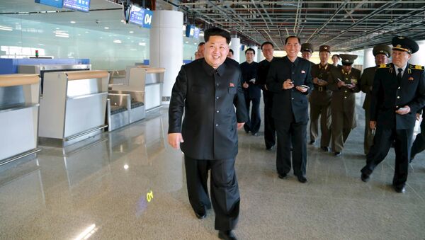 North Korean leader Kim Jong Un (front) smiles as he gives field guidance at the construction site of Terminal 2 of Pyongyang International Airport - Sputnik International