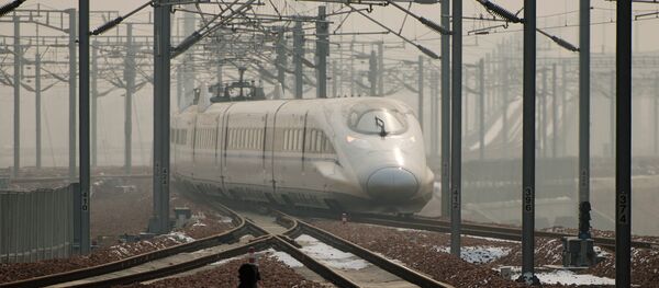 A high-speed train departs a platform in Hebei province south of Beijing on December 22, 2012 A high-speed train departs a platform in Hebei province south of Beijing on December 22, 2012 - Sputnik International