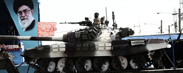 An Iranian soldier sitting atop a T-72 tank An Iranian soldier sitting atop a T-72 tank - Sputnik International