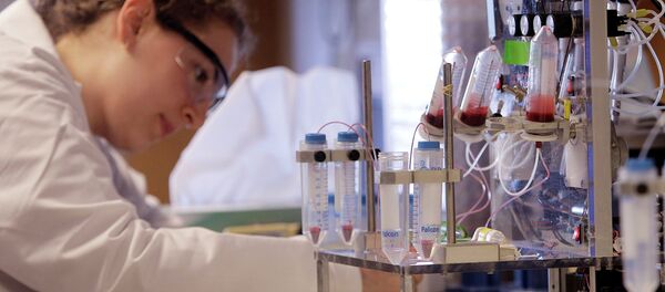 A researcher works near a blood test machine A researcher works near a blood test machine - Sputnik International