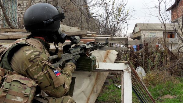 In this file photo dated Dec. 29, 2010, a Russian Special Forces officer aims his weapon during a security raid at a village outside Makhachkala, the regional capital of Russia's province of Dagestan - Sputnik International