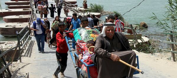 Displaced Sunni people, who fled the violence in the city of Ramadi, arrive at the outskirts of Baghdad, April 18, 2015 Displaced Sunni people, who fled the violence in the city of Ramadi, arrive at the outskirts of Baghdad, April 18, 2015 - Sputnik International