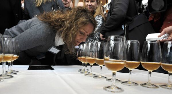 An unidentified woman smells the aroma of one of the 168 bottles of champagne salvaged from a 200-year-old shipwreck in the waters off Aland Islands, between Sweden and Finland, which was opened at a sampling in Mariehamn, Finland on Wednesday Nov. 17, 2010 An unidentified woman smells the aroma of one of the 168 bottles of champagne salvaged from a 200-year-old shipwreck in the waters off Aland Islands, between Sweden and Finland, which was opened at a sampling in Mariehamn, Finland on Wednesday Nov. 17, 2010 - Sputnik International
