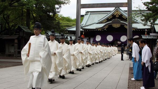 Shinto priests walk out from a gate after they administered a Shinto rite Kiyoharai on the first day of the three-day spring festival at the controversial Yasukuni shrine in Tokyo on April 21, 2015 - Sputnik International
