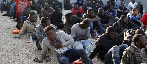 Illegal migrants sit in a coastal police base in Tripoli March 13, 2015 Illegal migrants sit in a coastal police base in Tripoli March 13, 2015 - Sputnik International