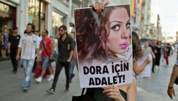 People march with a photograph of Dora Oezer, a transsexual Turkish woman, who according to local media was killed in Kusadasi, to protest violence against members of the gay and transsexual community members, in Istanbul, Turkey, Friday, July 12, 2013. File Photo - Sputnik International