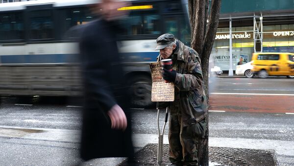 A homeless man begs for donations outside a subway station in New York on February 4, 2015 - Sputnik International