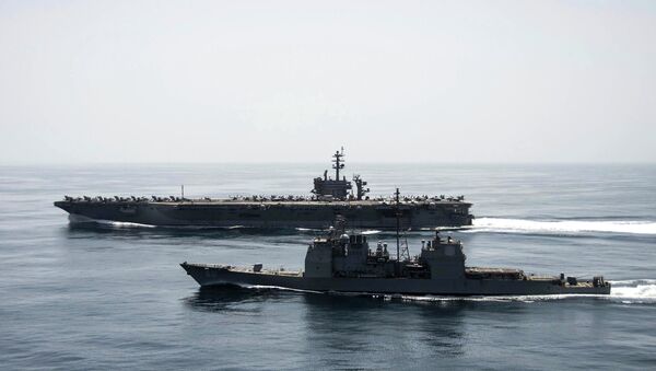The aircraft carrier USS Theodore Roosevelt (CVN 71) and the guided-missile cruiser USS Normandy (CG 60) operate in the Arabian Sea conducting maritime security operations in this U.S. Navy photo taken April 21, 2015 - Sputnik International