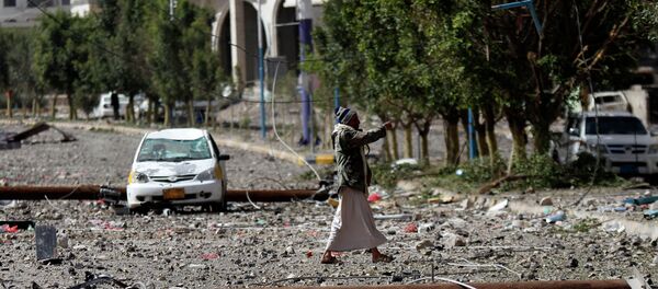A Shiite fighter known as Houthi, walks on a street littered by debris after a Saudi-led airstrike hit a site where many believe the largest weapons cache in Yemen's capital, Sanaa, is located on Monday, April 20, 2015 A Shiite fighter known as Houthi, walks on a street littered by debris after a Saudi-led airstrike hit a site where many believe the largest weapons cache in Yemen's capital, Sanaa, is located on Monday, April 20, 2015 - Sputnik International