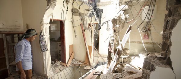A man looks at damage in his house caused by an April 20 air strike that hit a nearby army weapons depot in Sanaa April 21, 2015 A man looks at damage in his house caused by an April 20 air strike that hit a nearby army weapons depot in Sanaa April 21, 2015 - Sputnik International