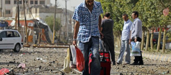 A man carries his belongings on a street of Sanaa. A man carries his belongings on a street of Sanaa. - Sputnik International