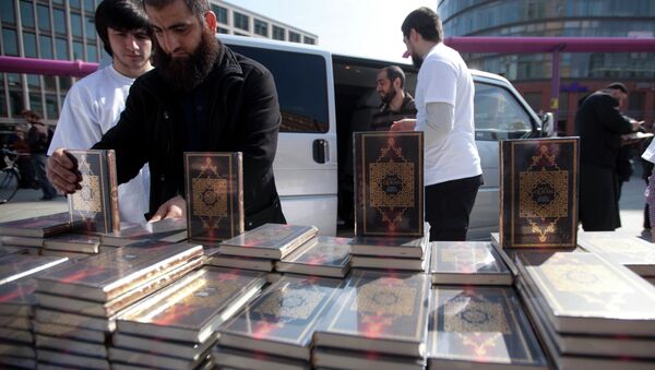 Members of a Muslim group pile Qurans while distributing copies of it at Potsdamer Platz in Berlin, Saturday, April 14, 2012. - Sputnik International