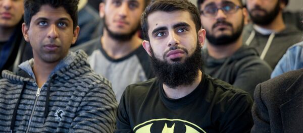 Students at Queens College in New York gather for a vigil, Wednesday, Feb. 18, 2015, in honor of three Muslim students killed recently near the University of North Carolina Students at Queens College in New York gather for a vigil, Wednesday, Feb. 18, 2015, in honor of three Muslim students killed recently near the University of North Carolina - Sputnik International