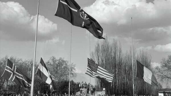 Soldiers hoist the flags of the members countries of the Atlantic Alliance (NATO) during the farewell ceremony at the SHAPE (Supreme Headquarters Allied Powers Europe) in Rocquencourt, Paris suburb, on March 31, 1967. - Sputnik International