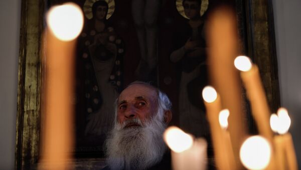 An eldery man attends a religious service at the cathedral in Etchmiadzin, outside Yerevan - Sputnik International