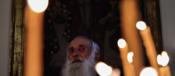 An eldery man attends a religious service at the cathedral in Etchmiadzin, outside Yerevan - Sputnik International