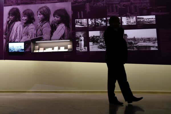 A man stands by archive photographs during an exhibition about the Armenian Genocide at the Armenian Genocide Museum in Yerevan on April 21, 2015. A man stands by archive photographs during an exhibition about the Armenian Genocide at the Armenian Genocide Museum in Yerevan on April 21, 2015. - Sputnik International