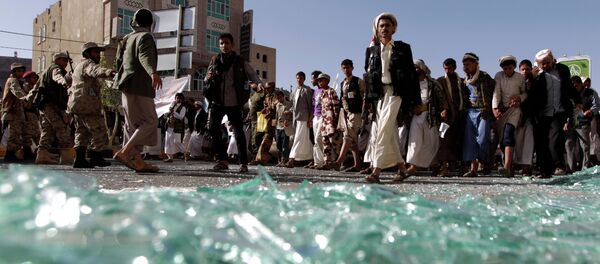 Supporters of the Shiite Huthi movement walk on shattered glass as they take part in a demonstration in the capital Sanaa on April 22, 2015 - Sputnik International