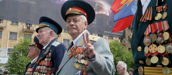 Former Soviet Union army veterans march during a Victory Day celebration, which commemorates the 1945 defeat of Nazi Germany, in the center of Kharkiv, Ukraine, Friday, May 9, 2014 - Sputnik International