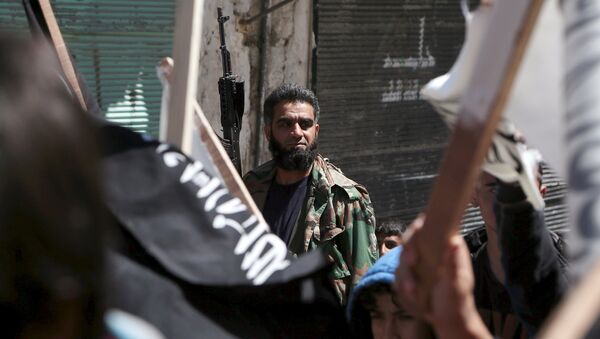 A rebel fighter attends a demonstration celebrating Nusra Front's take over of Idlib about a month ago and calling for the implementation of the Islamic Sharia law, in Al-Sakhour neighborhood of Aleppo - Sputnik International