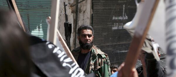 A rebel fighter attends a demonstration celebrating Nusra Front's take over of Idlib about a month ago and calling for the implementation of the Islamic Sharia law, in Al-Sakhour neighborhood of Aleppo A rebel fighter attends a demonstration celebrating Nusra Front's take over of Idlib about a month ago and calling for the implementation of the Islamic Sharia law, in Al-Sakhour neighborhood of Aleppo - Sputnik International