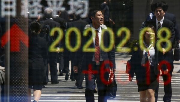 People are reflected in an electronic board displaying Japan's Nikkei share average outside a brokerage in Tokyo April 23, 2015 - Sputnik International