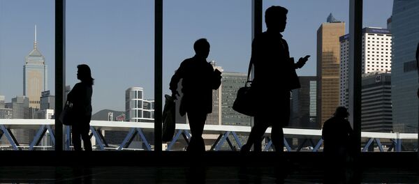 Mainland Chinese visitors admire the skyline of the financial Central district inside a shopping mall in Hong Kong April 14, 2015 Mainland Chinese visitors admire the skyline of the financial Central district inside a shopping mall in Hong Kong April 14, 2015 - Sputnik International