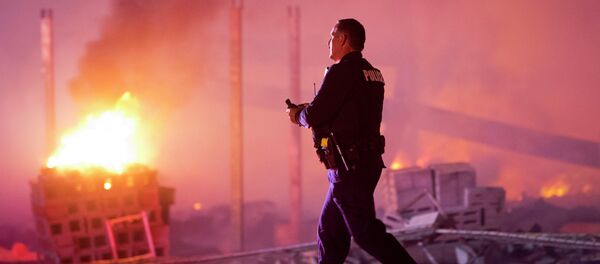 A police officer walks by a blaze, Monday, April 27, 2015, after rioters plunged part of Baltimore into chaos, torching a pharmacy, setting police cars ablaze and throwing bricks at officers A police officer walks by a blaze, Monday, April 27, 2015, after rioters plunged part of Baltimore into chaos, torching a pharmacy, setting police cars ablaze and throwing bricks at officers - Sputnik International