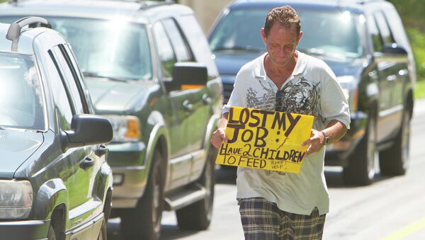 A man tries to collect money for his family on a Miami street corner, two months after losing his job. - Sputnik International