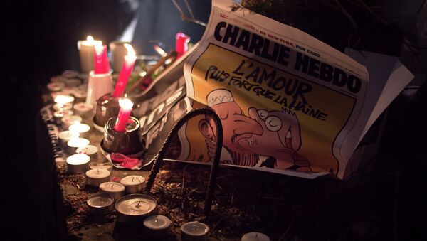 A copy of the Charlie Hebdo issue printed after the massacre at their Paris offices is placed at an impromptu memorial in Brussels during a solidarity gathering. The text reads Love is stronger than hate. - Sputnik International
