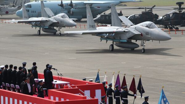 Japanese Prime Minister Shinzo Abe reviews Japan Self-Defense Forces' F-15J fighter jets at Hyakuri Air Base. - Sputnik International