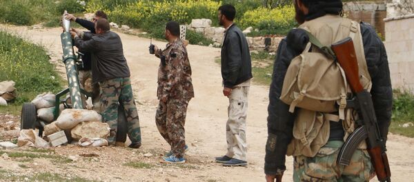 Free Syrian Army fighters of the 101 Infantry Division (the missile and artillery battalion) prepare to fire a mortar from Jabal al-Arbaeen towards al-Fanar checkpoint in Ariha, which is controlled by forces loyal to Syria's President Bashar al-Assad, in Idlib countryside April 16, 2015 - Sputnik International
