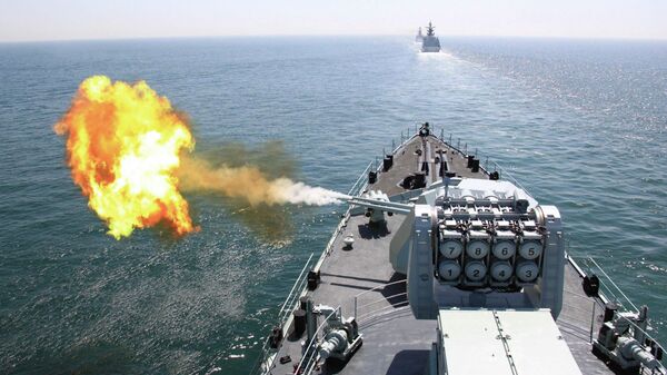 In this April 26, 2012 file photo released by China's Xinhua News Agency, Chinese navy's missile destroyer DDG-112 Harbin fires a shell during the China-Russia joint naval exercise in the Yellow Sea - Sputnik International