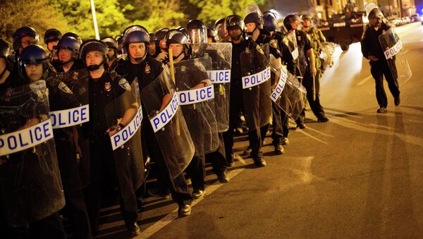 Police in riot gear line up near the scene of Monday's riots ahead of a 10 p.m. curfew Wednesday, April 29, 2015, in Baltimore. The curfew was imposed after unrest in Baltimore over the death of Freddie Gray while in police custody. - Sputnik International